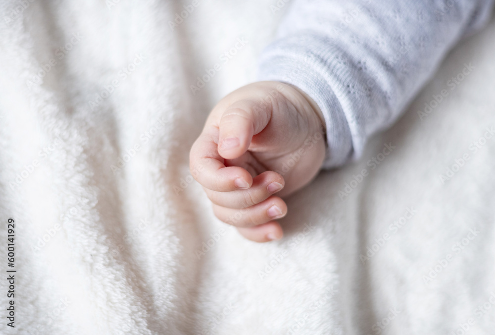 close up baby small hand and legs feet toes.barefoot little toddler infant lying on bed relax at home.motherhood concept. close up baby small hand and legs feet toes.barefoot little toddler infant lying on bed relax at home.motherhood concept.