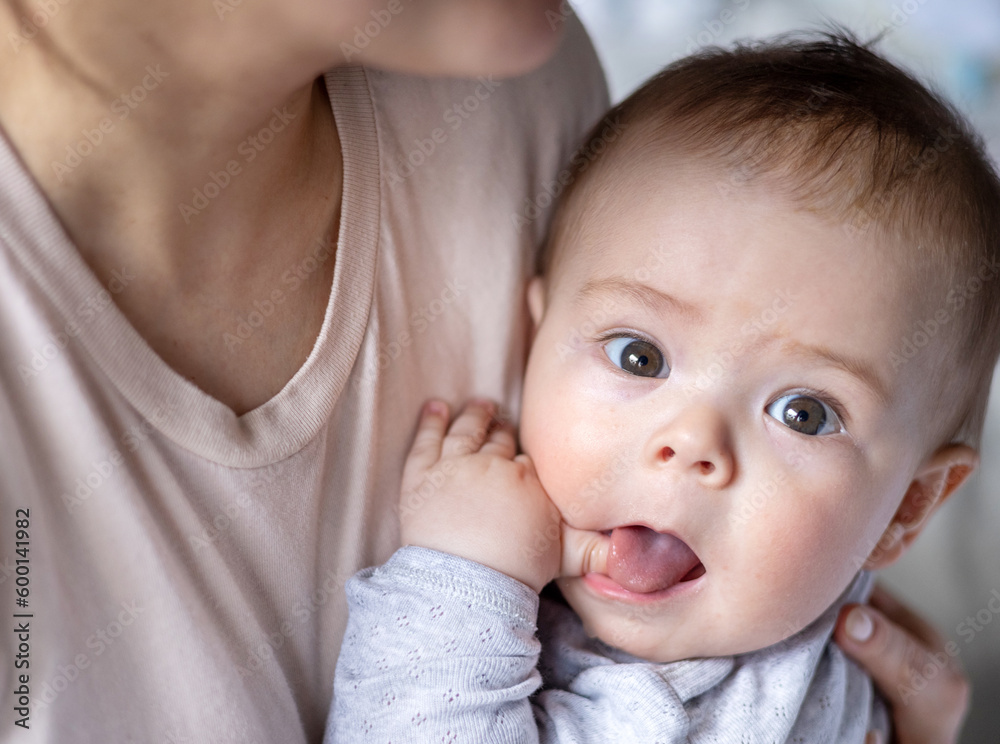 cute baby boy is lying on bed or sitting in mother arms,beautiful child big eyes.mommy woman kissing caresses toddler on neck cheek.happy smiling new born portrait.loving mom in motherhood cute baby boy is lying on bed or sitting in mother arms,beautiful child big eyes.mommy woman kissing caresses toddler on neck cheek.happy smiling new born portrait.loving mom in motherhood