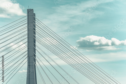 Close up detail with a cable stayed suspension bridge against the blue sky