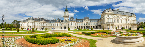 Keszthely, Beautiful Baroque Palace of the Festetics family (Helikon Palace Museum) Historical architecture in Hungary Panorama blue sky with picturesque clouds, spring gardens. Keszthely 30.04.2023