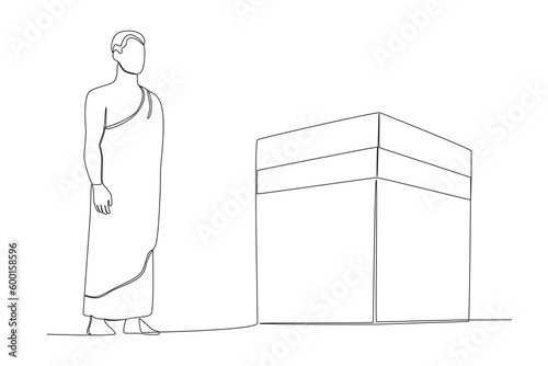 A male pilgrim standing beside the kabba. Hajj pilgrims one-line drawing
