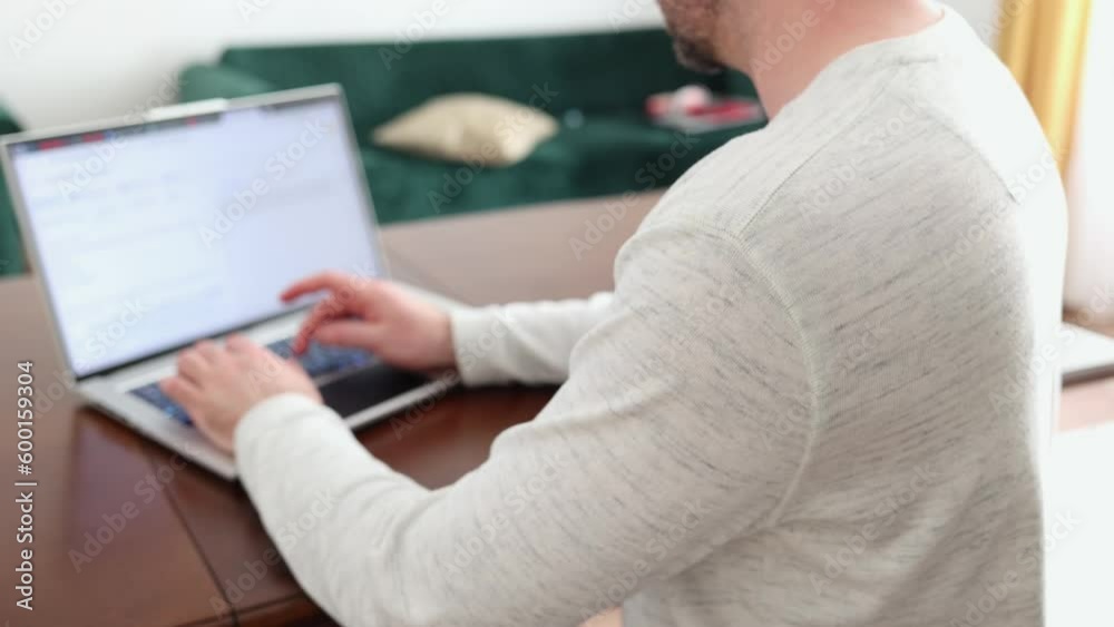 Worker is using at laptop. Close up view of male shoulders. Concept of remote work, freelance and online hr Worker is using at laptop. Close up view of male shoulders. Concept of remote work, freelance and online hr