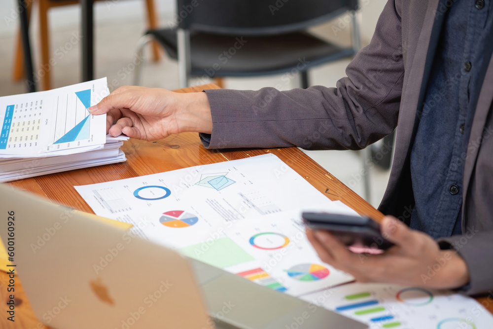 Asian business team consists of marketing staff. accountant and financial officer Help each other analyze company profits using tablets. calculator Laptop computers, graph paper, and corporate pens. Asian business team consists of marketing staff. accountant and financial officer Help each other analyze company profits using tablets. calculator Laptop computers, graph paper, and corporate pens.