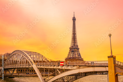 The Eiffel Tower and the arching Pont d'Iéna Bridge at sunrise over the Seine River in Paris, France © Naya Na
