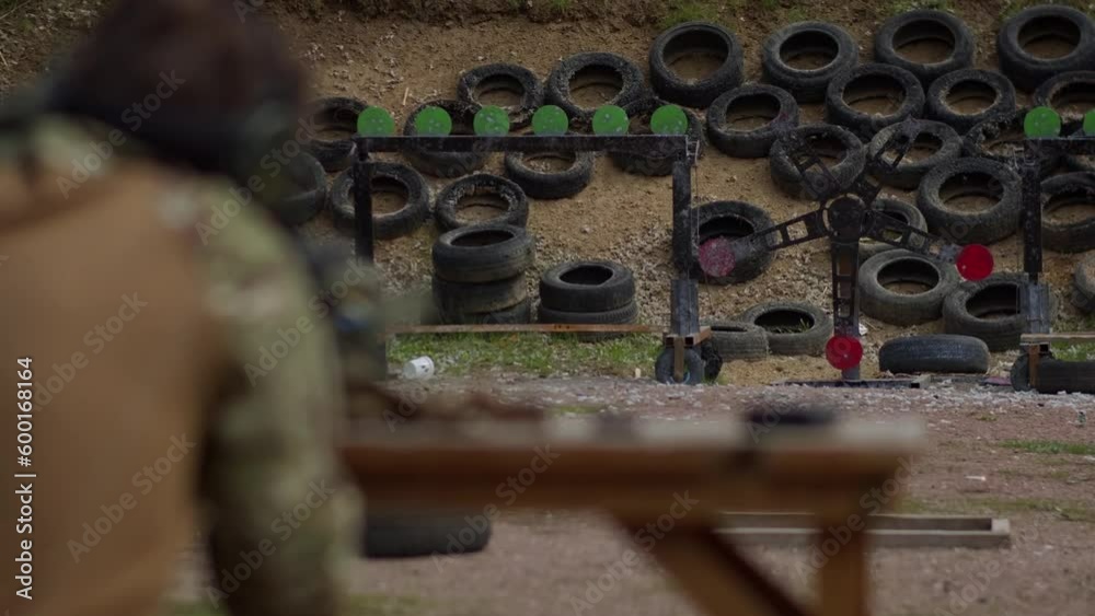 a man shoots a carbine at a target and miss in slow motion a man shoots a carbine at a target and miss in slow motion