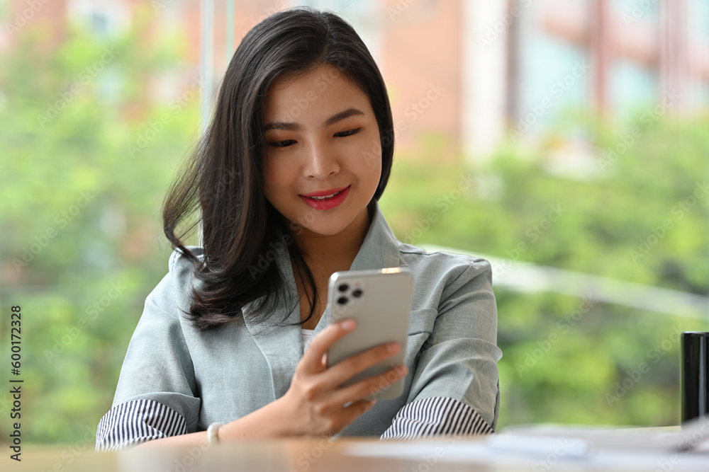 Portrait with Smiling of Young Asian Businesswoman enjoy with her mobile phone. Portrait with Smiling of Young Asian Businesswoman enjoy with her mobile phone.