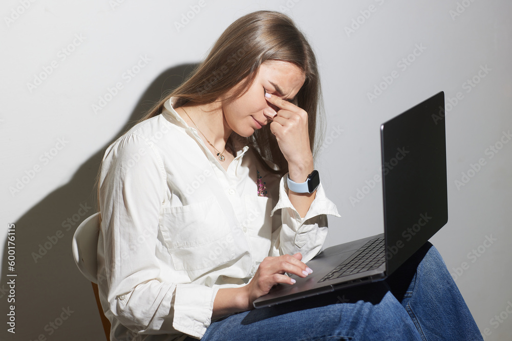tired girl with laptop on white background tired girl with laptop on white background