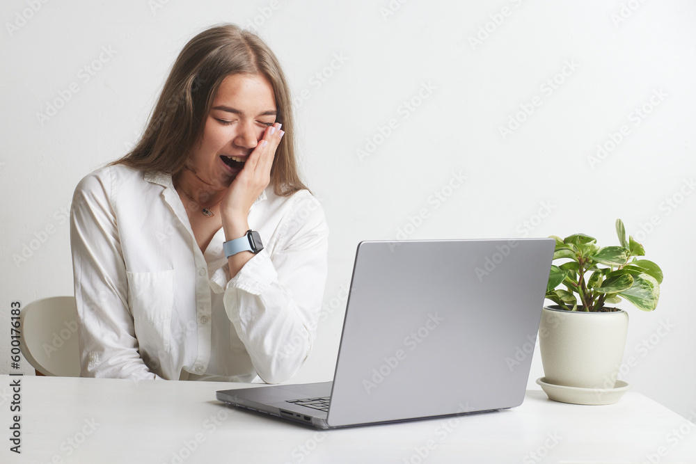 tired girl with laptop on white background tired girl with laptop on white background