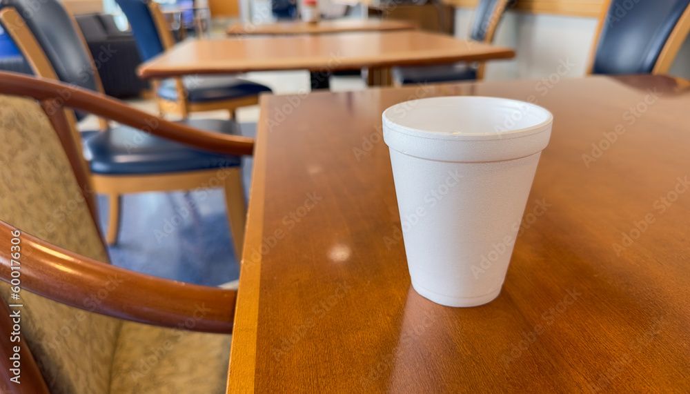 styrofoam cup on the table symbolizes convenience and disposability