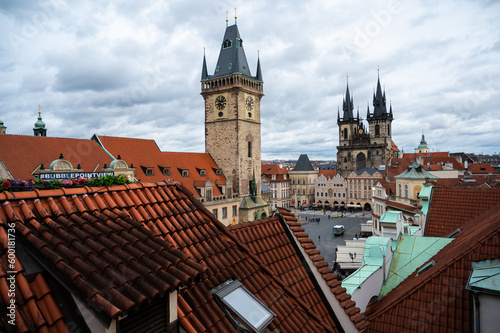 Prague beautiful panoramic sunny aerial drone view above Prague Old Town Square with Church of Our Lady before Tyn and Prague Astronomical Clock Tower. Drone flight over red roofs of Prague, Czechia. 