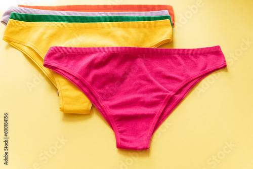 Set of colorful underpants on yellow background, close up