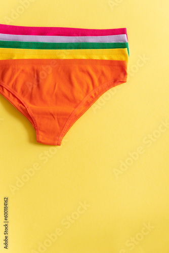 Set of colorful underpants on yellow background  close up