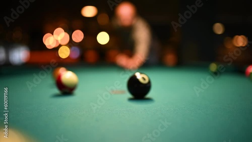 Man breaks spheres in billiard photo