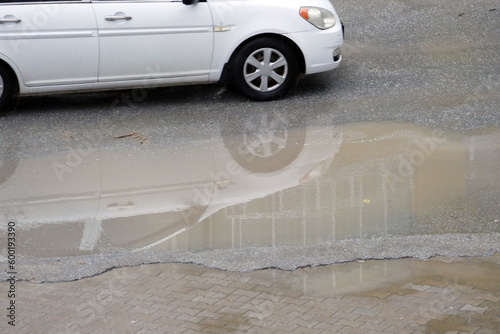 puddles on city pavements and roads after rain, unplanned urbanization,