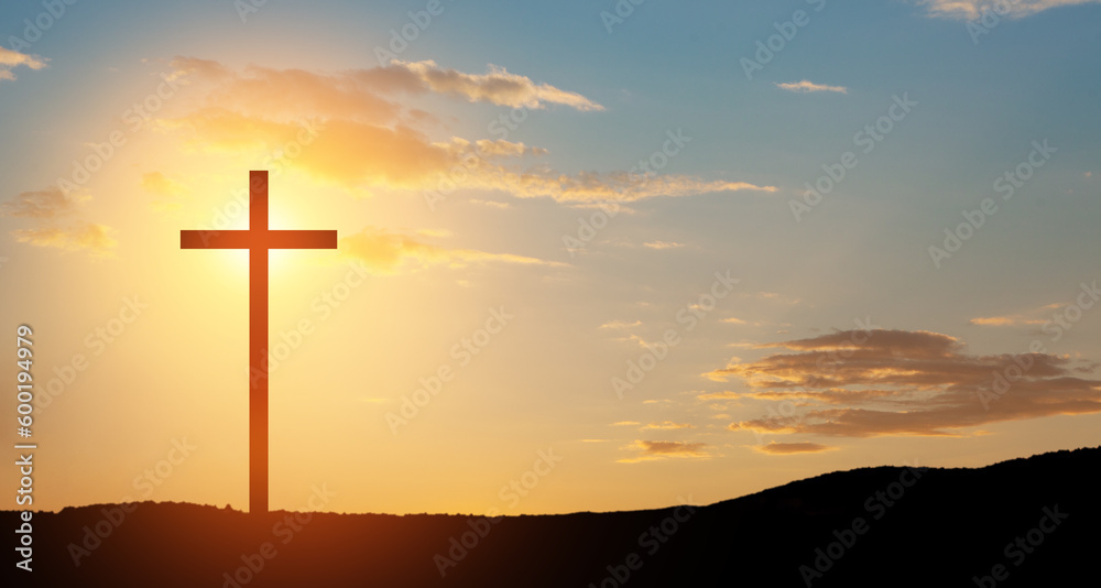 Christian cross on hill outdoors at sunrise. Resurrection of Jesus.