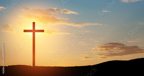 Christian cross on hill outdoors at sunrise. Resurrection of Jesus. © hamara