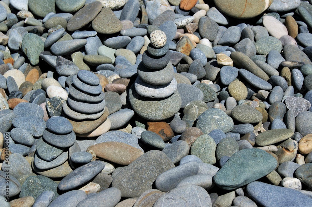 Zen stone towers on a rocky beach on a sunny day, Zen stone towers on a rocky beach on a sunny day,