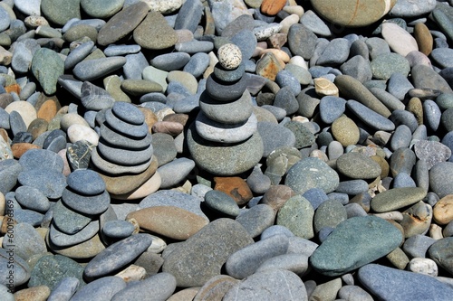 Zen stone towers on a rocky beach on a sunny day 