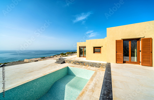 se or villa in light yellow color under constraction and empty swimming pool.