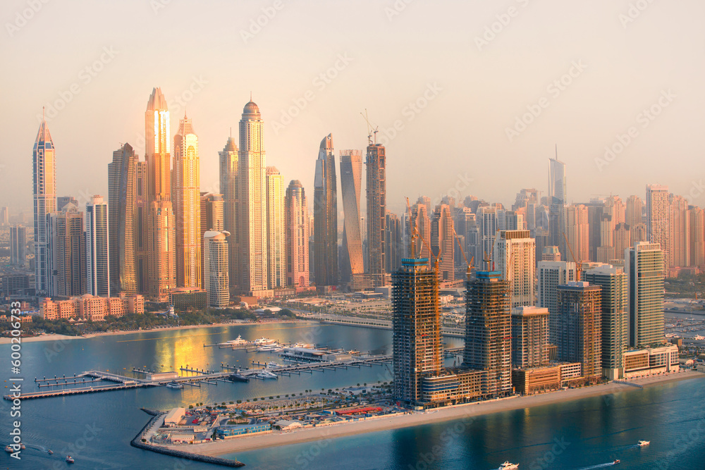 Fototapeta premium Dubai Marina skyscrapers view at golden sunset with beautiful reflection in water. Dubai, UAE.