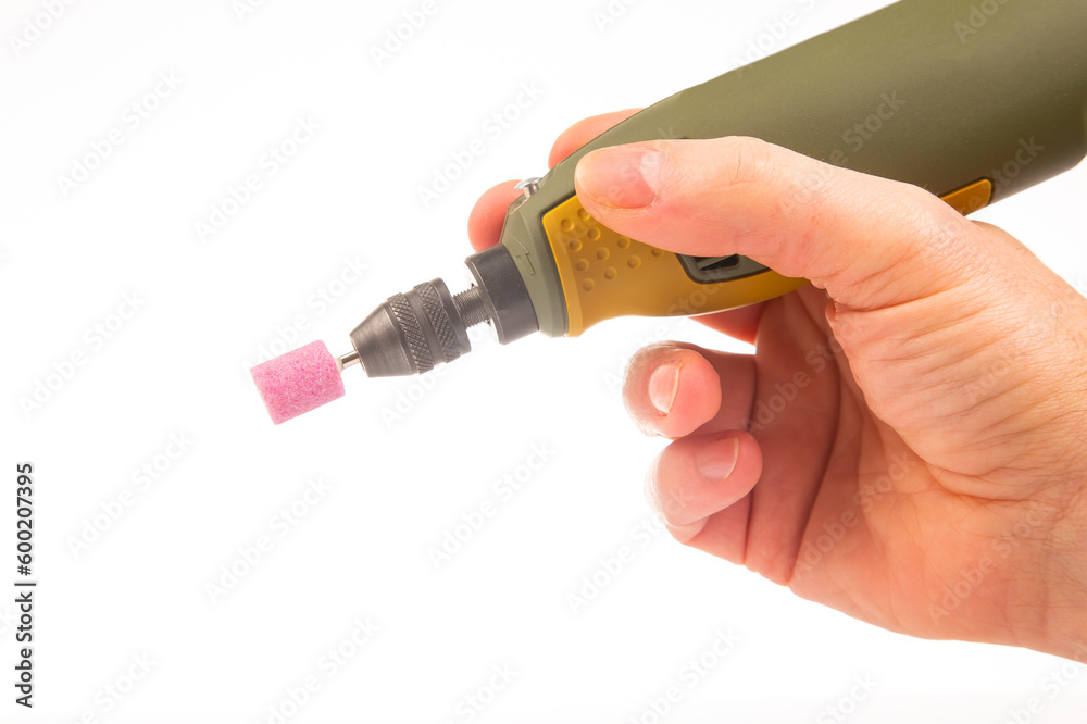 graver and drilling electric tool on a white background. dremel for processing materials and repairing parts graver and drilling electric tool on a white background. dremel for processing materials and repairing parts