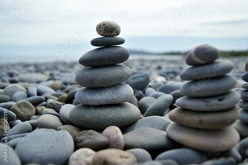 Towers made of pebbles. Two Zen towers on a rocky beach.