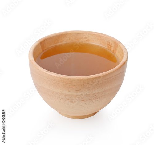 Mitragyna speciosa water in wooden bowl isolated on white background.
