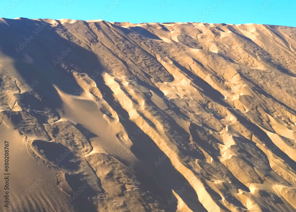 Fototapeta premium Untouched natural sand dunes with blue sky good for nature background