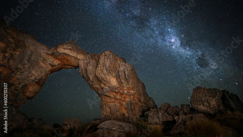 Canvas Print Milky Way galaxy rising in the night sky with rock arch in the foreground, Ceder