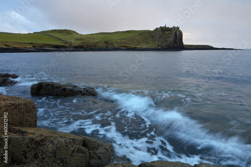 Incoming tide at Sunset with Duntulm Castle in the background, Isle of Skye, Scotland, UK. photo