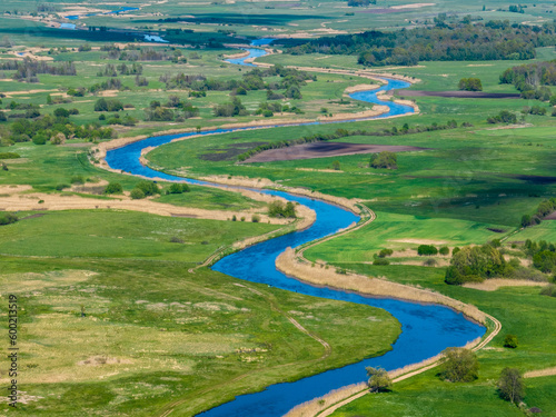 Meandering Narew river near Tykocin in Poland - drone aerial view, landscape photography, green fields, meadows, sunny day © Łukasz Tyczkowski