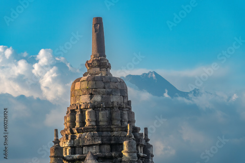 Ancient temple ruins of Sewu  candi sewu   an eighth century Mahayana Buddhist temple complex  Prambanan  Central Java  Indonesia. The Mount Merapi volcano in the background