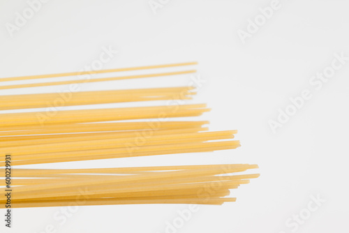 Spaghetti spread out on a white surface.