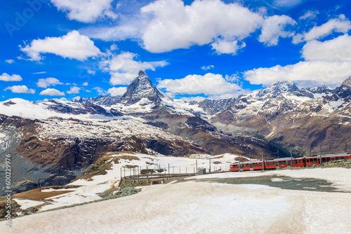 Scenic view on snowy Matterhorn mountain peak in the Swiss Alps with cogwheel train of Gornergrat railway close to Zermatt, Switzerland