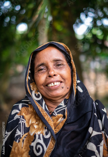 Portrait of a south asian elderly grandmother, asian woman in traditional dress, black skin lesion on face 