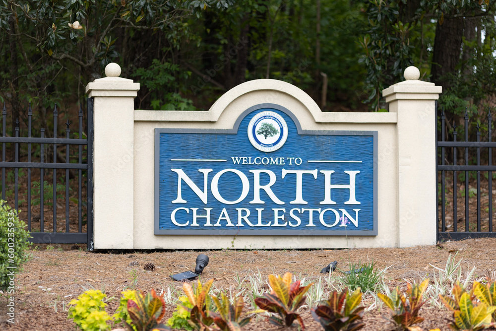 Obraz premium North Charleston, South Carolina city limits welcome sign with trees and flowers off of interstate I-26 in South Carolina