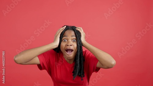 Surprised african woman gesturing and looking at the camera