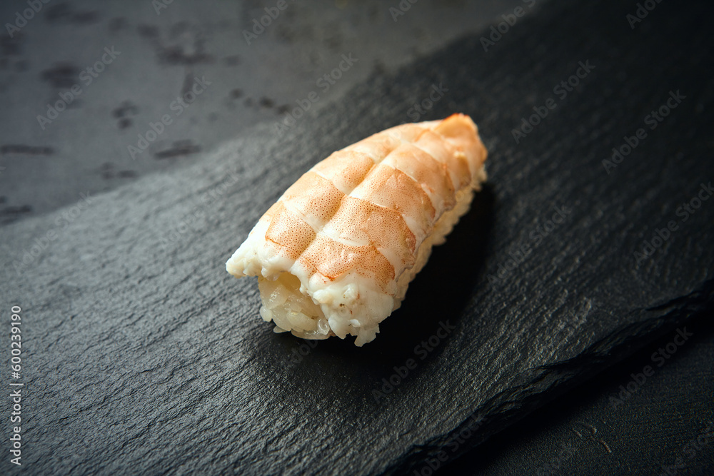 Nigiri Sushi with shrimp on dark background. Sushi menu. Japanese food. Nigiri Sushi with shrimp on dark background. Sushi menu. Japanese food.