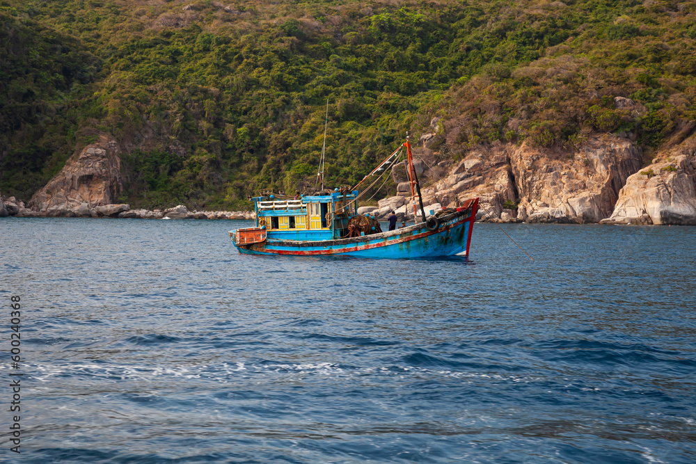 Fishing boat at Rocky coastal landscape, South China Sea, Vinh hy, Province of Ninh Thuan, Vietnam, Asia Fishing boat at Rocky coastal landscape, South China Sea, Vinh hy, Province of Ninh Thuan, Vietnam, Asia