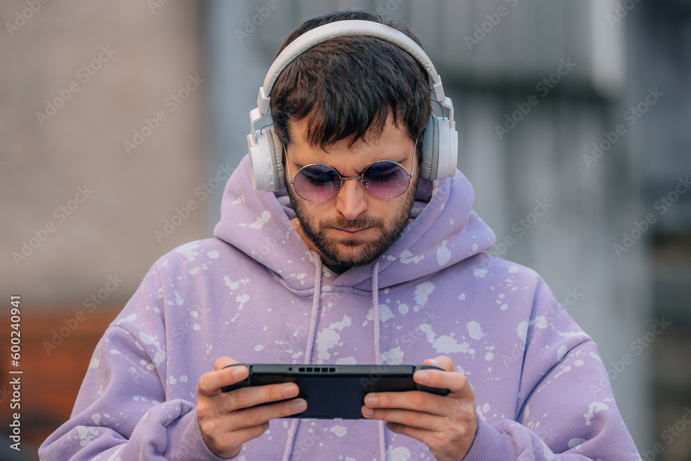 young man with headphones and console playing online, gaming young man with headphones and console playing online, gaming