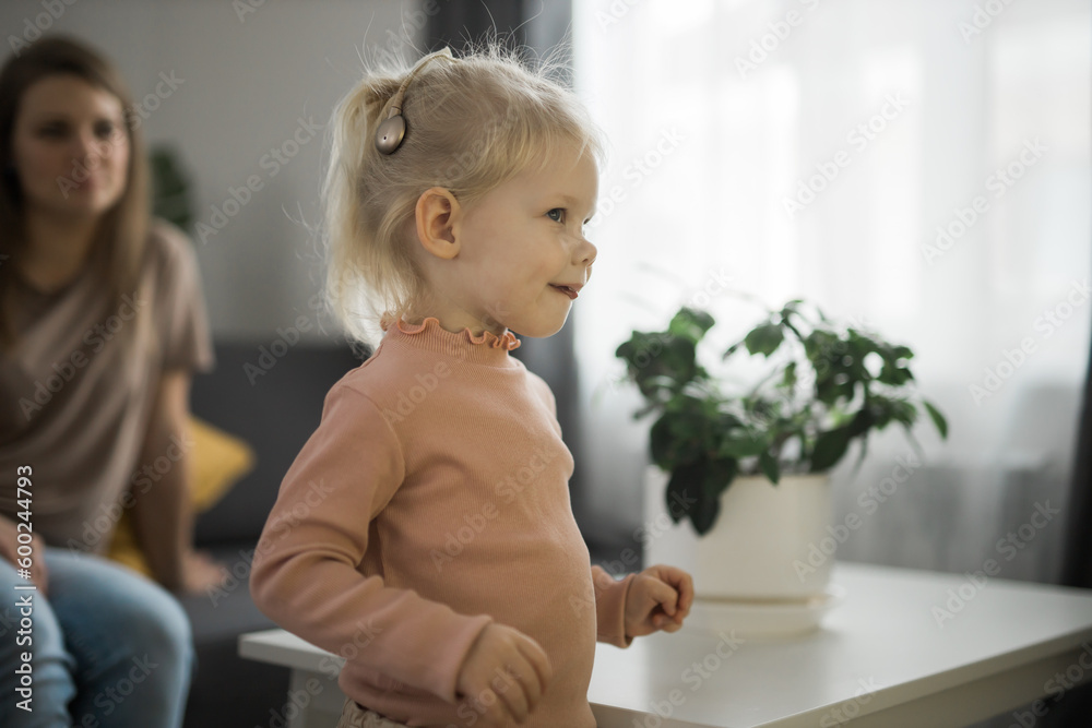 Deaf kid with hearing aid cochlear implant - Hear aid and medicine innovating technology and diversity concept Deaf kid with hearing aid cochlear implant - Hear aid and medicine innovating technology and diversity concept
