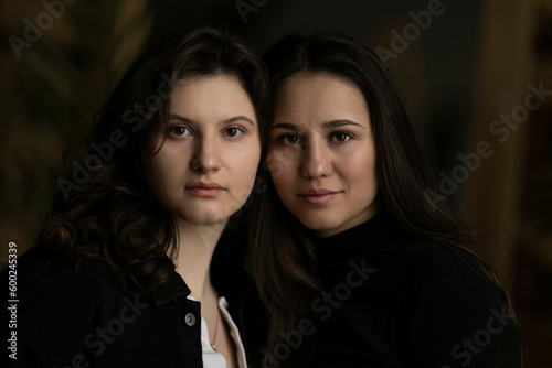 Closed image of a two young women, looking at camera.
