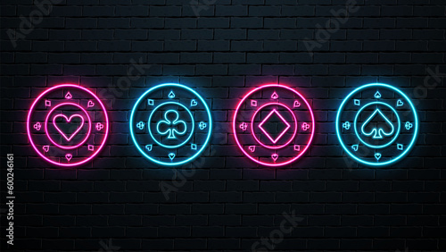 Neon casino chips on a brick wall background.