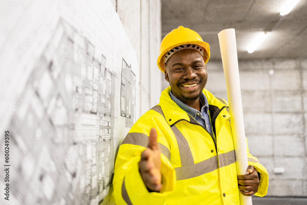 Construction worker job and career. Portrait of engineer in protective equipment holding blueprint at the building site. Construction worker job and career. Portrait of engineer in protective equipment holding blueprint at the building site.