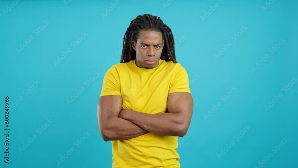 Latin man with dreadlocks crossing the arms with angry expression Latin man with dreadlocks crossing the arms with angry expression