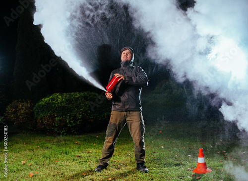 Young man testing fire extinguisher