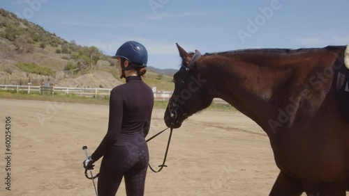 Woman horse rider walking with horse in countryside horse ranch