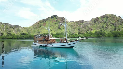 Aerial video of a private charter Arua floating on the sea of Komodo Island, Indonesia photo