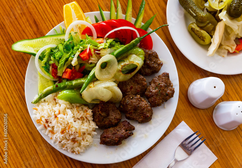 Plate of turkish kofte meatballs with rice and salad