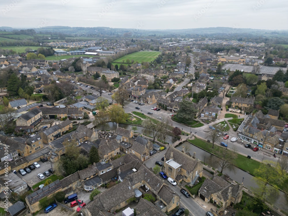 Bourton on the Water Cotswold village UK drone aerial view .in spring.